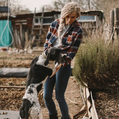 young-woman-with-blond-hair-petting-her-dog-on-the-2026-01-06-09-42-57-utc